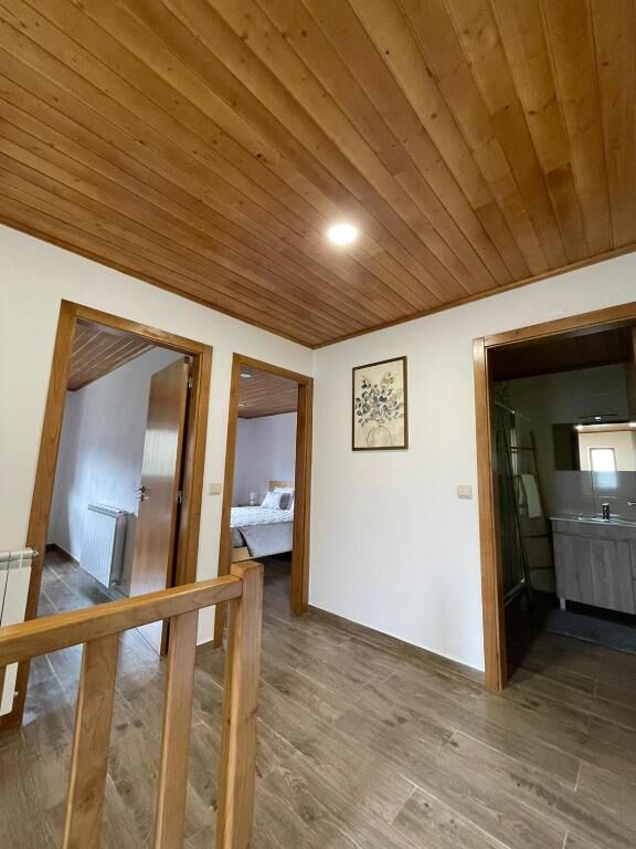 Upstairs hall with wooden ceiling and doorways